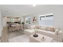 Bright open-concept living room showcases neutral decor, wood floors, and large windows at 5844 Sw 87Th Ave, Ocala, FL 34481