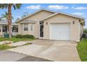 Charming single-story home with neutral siding, front yard, and attached garage at 50989 Highway 27 # 179, Davenport, FL 33897