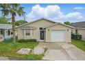 Charming single-story home with neutral siding, front yard, and attached garage at 50989 Highway 27 # 179, Davenport, FL 33897