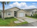 Charming single-story home with neutral siding, front yard, and attached garage at 50989 Highway 27 # 179, Davenport, FL 33897