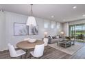 Open-concept living and dining area with modern decor and plenty of natural light at 5832 Sw 87Th Ave, Ocala, FL 34481