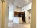 Bright eat-in kitchen featuring stainless steel appliances, wooden cabinets, and neutral tile flooring at 13103 Mulberry Park Dr # 833, Orlando, FL 32821
