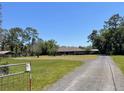Spacious lot with a well maintained yard, gravel driveway, and lovely, one-story home at 1275 Man O War Dr, Deland, FL 32724
