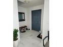 Bright entryway with sleek marble floors, a modern door, mirror, and shoe rack at 1416 Aguacate Ct, Orlando, FL 32837