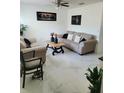 Comfortable living room showcasing neutral tones, marble floors, stylish furniture and modern decor at 1416 Aguacate Ct, Orlando, FL 32837