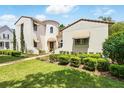 Charming two-story home with a tile roof and lush green lawn at 1239 Roycroft Ave, Kissimmee, FL 34747