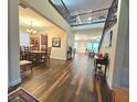 Open-concept foyer with wood floors, high ceilings, and views into the living and dining spaces at 13525 Gorgona Isle Dr, Windermere, FL 34786