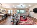 Bright living room with a large sectional couch, wood floors, and natural light at 13525 Gorgona Isle Dr, Windermere, FL 34786