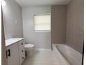 Modern bathroom featuring neutral tile, vanity with storage, and a bathtub at 1505 Piedmont Dr, Deltona, FL 32725