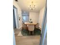 Charming dining room features a round wood table, modern chandelier, and colorful rug, perfect for gatherings at 1505 Piedmont Dr, Deltona, FL 32725