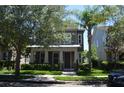 Charming two-story home featuring a welcoming front porch and well-manicured landscaping at 11578 Ashlin Park Blvd, Windermere, FL 34786