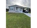Charming single-story home featuring a carport and well-maintained lawn at 118 Jana Cir, Auburndale, FL 33823