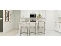 Kitchen island with white countertop and bar stools in a modern kitchen at 1914 Sarah St, Winter Haven, FL 33884