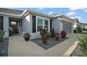 Beautiful home exterior with a welcoming entrance, garden, and well-kept walkway at 5754 Shealy Ave, The Villages, FL 32163