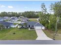 Aerial view of a single Gathering home with a large front yard and attached two car garage at 6873 Sw 131St Pl, Ocala, FL 34473