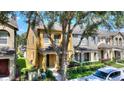 A two-story townhome with a covered entry and landscaped front yard at 7752 Moser Ave, Windermere, FL 34786
