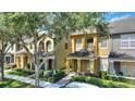 Two-story townhome with covered entry, and landscaped front yard at 7752 Moser Ave, Windermere, FL 34786