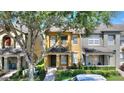 Charming two-story townhome featuring a covered entryway and landscaped front yard at 7752 Moser Ave, Windermere, FL 34786