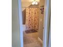 View of the bathroom with tile flooring and shower with curtain at 2605 Gala S Rd, Kissimmee, FL 34746