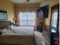 Bedroom featuring carpet, a large window, and a ceiling fan at 2605 Gala S Rd, Kissimmee, FL 34746