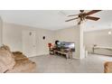 The living room features tile floors, neutral walls and a ceiling fan at 995 Merrimac St, Deltona, FL 32725