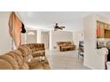 Open concept living room with tiled floor and ceiling fan at 995 Merrimac St, Deltona, FL 32725