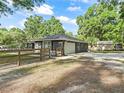Side view of home featuring an attached garage, fenced yard, and a well-maintained lawn at 5434 Se 39Th Ave, Ocala, FL 34480