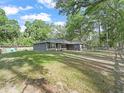 A view of the home from the side yard showcasing its spacious lawn and inviting exterior at 5434 Se 39Th Ave, Ocala, FL 34480