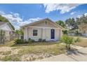 Charming exterior view of home with neutral paint, simple landscaping, and sidewalk at 701 N Vermont Ave, Lakeland, FL 33801