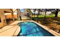Backyard pool with clear blue water, a screened-in enclosure and comfortable patio furniture at 1142 Mariner Cay Dr, Haines City, FL 33844