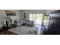 Spacious living room with a comfortable sectional sofa and large windows at 14845 Huntley Dr, Orlando, FL 32828