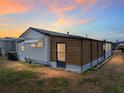 View of the home's exterior with unique wood slat design and metal roof at 3043 Sego Ln, Lakeland, FL 33801