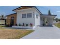 View of the front of the home highlighting a new driveway and landscaping at 3043 Sego Ln, Lakeland, FL 33801