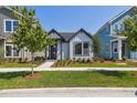 Inviting single-story home with manicured lawn and landscaping, showcasing a stylish, contemporary design at 3102 Voyager Ave, St Cloud, FL 34771
