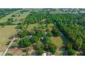Aerial view of property surrounded by lush greenery and horse pastures, bordered by a vibrant red line at 7795 Sw 72Nd Ct, Ocala, FL 34476