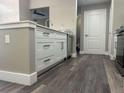 A kitchen has white cabinets, stainless steel appliances, a backsplash and dark, waterproof flooring at 12020 Villanova Dr # 107, Orlando, FL 32837