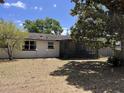 Back exterior view with a screened porch and a well maintained lawn at 1230 Jasmine Rd, Apopka, FL 32703