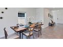Contemporary dining area featuring stylish wood table set for six with modern decor and lots of natural light at 5629 Gingham Dr, Kissimmee, FL 34758