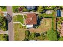 Birds eye view of a charming home with terracotta roof, patio, and landscaped yard at 2417 Coventry Ave, Lakeland, FL 33803