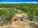 Scenic aerial view of a home with a pond, lush greenery, and beautiful landscaping at 9526 Turkey Oak Bnd, Orlando, FL 32817
