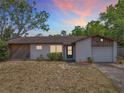 Inviting single-story home displaying a cozy facade and attached garage at 9526 Turkey Oak Bnd, Orlando, FL 32817