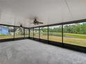 Spacious screened-in patio showcasing a tranquil view of the pond and backyard at 9526 Turkey Oak Bnd, Orlando, FL 32817