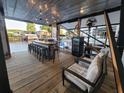Spacious outdoor kitchen on the water with bar seating and relaxing lounge area at 166 Catfish St, Haines City, FL 33844