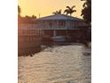 Waterfront home with boat lift and picturesque water views at sunset at 166 Catfish St, Haines City, FL 33844