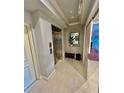 Hallway view with elevator, tiled floor and decor in neutral colors at 10091 Lake Cove Dr # 301, Fort Myers, FL 33908