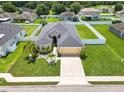 An aerial view of a well-manicured property featuring lush green lawn and white vinyl fencing at 4662 Harts Brook Ln, Mulberry, FL 33860