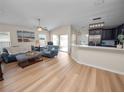 Open concept living room showcasing hardwood floors and backyard views at 4662 Harts Brook Ln, Mulberry, FL 33860