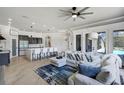 Open-concept living room featuring wood floors, modern decor, and stylish furnishings at 655 Whisper Woods Dr, Lakeland, FL 33813
