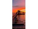 Scenic view of a private dock at sunset, perfect for relaxing or fishing at 1395 S Lake Reedy Blvd, Frostproof, FL 33843