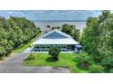 A charming home with a metal roof and screened-in porch near a picturesque lake at 1395 S Lake Reedy Blvd, Frostproof, FL 33843